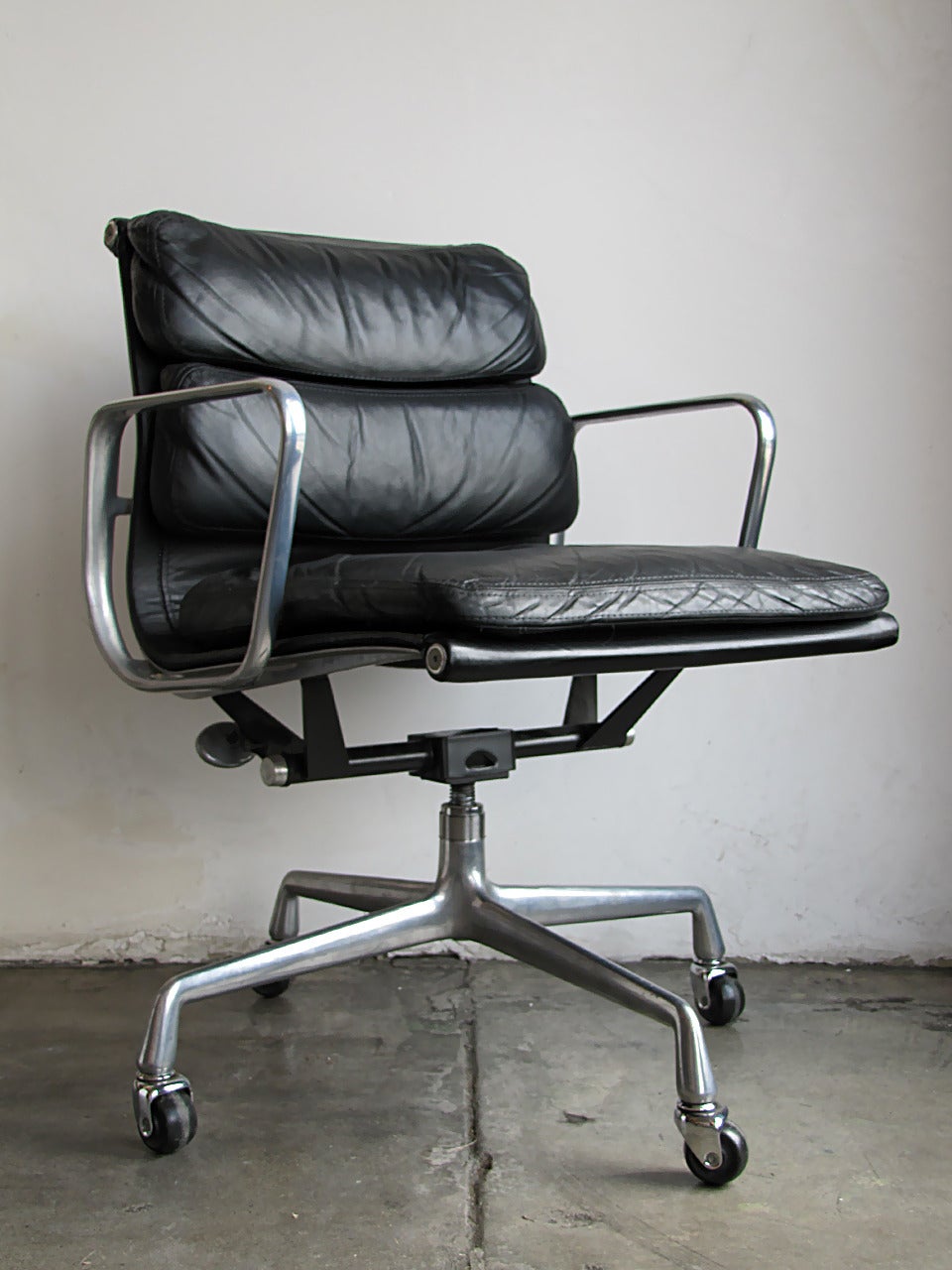 Early black leather Charles Eames for Herman Miller soft pad desk chair, height adjustable, swivel and tilt limiter, early four star wheel base, marked.