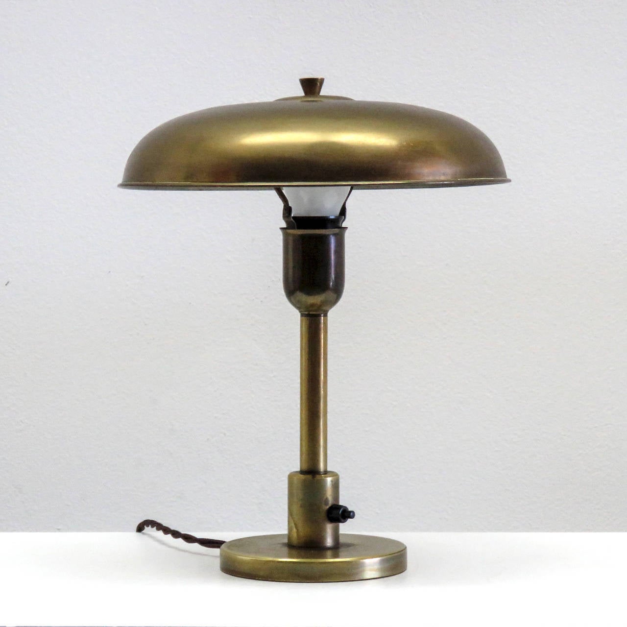 wonderful petite 1930s Danish table lamp in brass, with tilting shade and on/off switch at the stem.