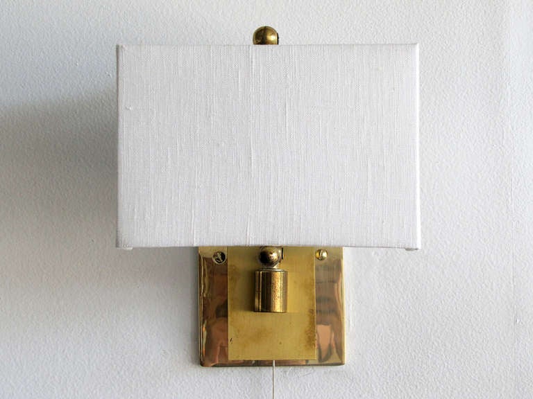 wonderful pair of dual position wall sconces, the articulate brass arm allows for 180 degree movement, the max protrusion with the arm in a horizontal position is 8