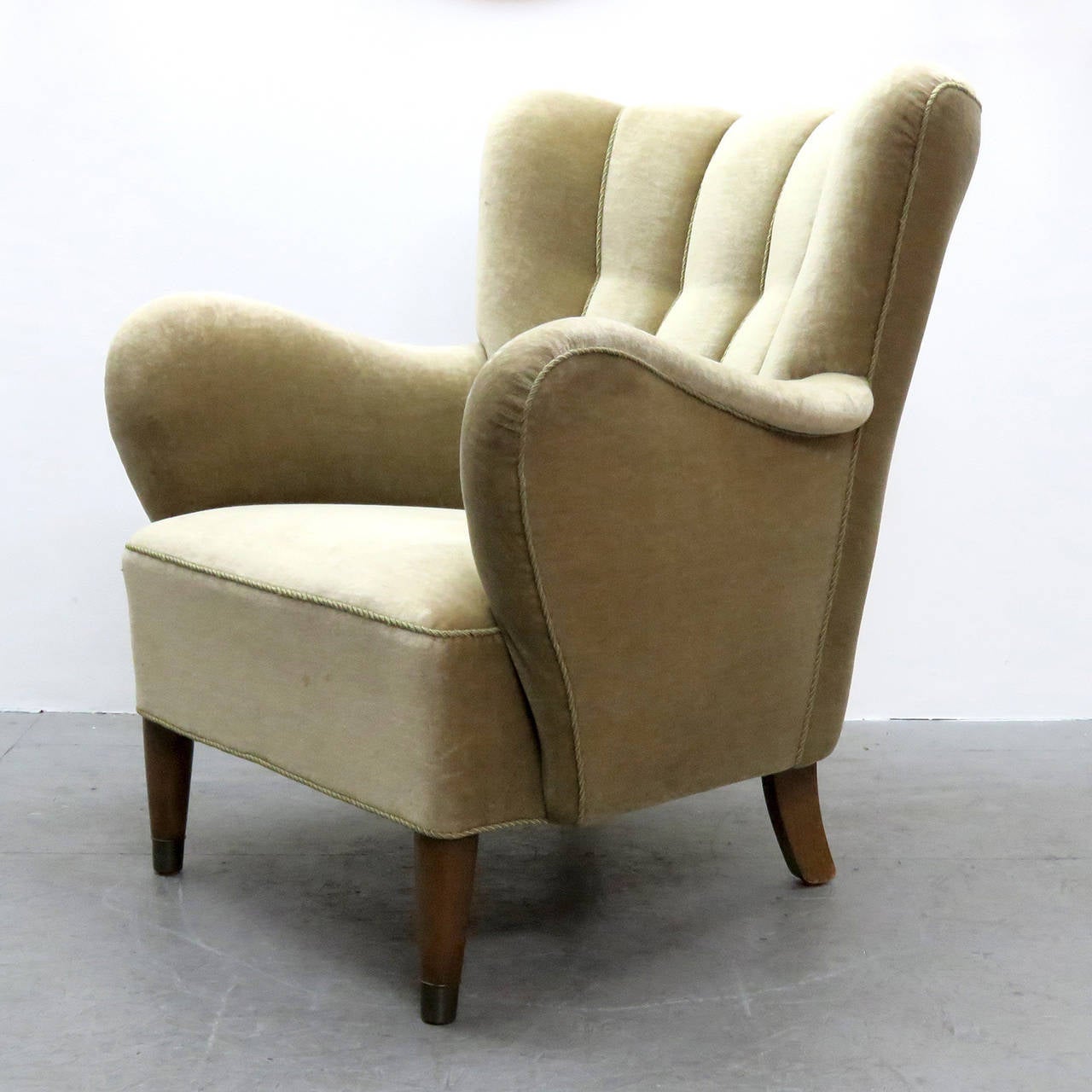 Comfortable, channeled Danish mohair club chair with teak legs finished with brass caps.