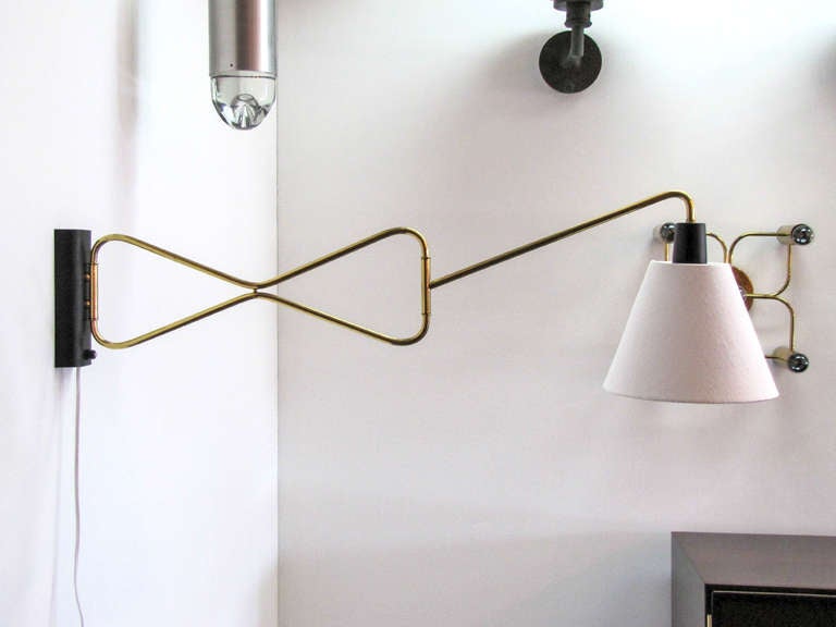 elegant double-fold brass swing arm wall light with custom conical shade and cord