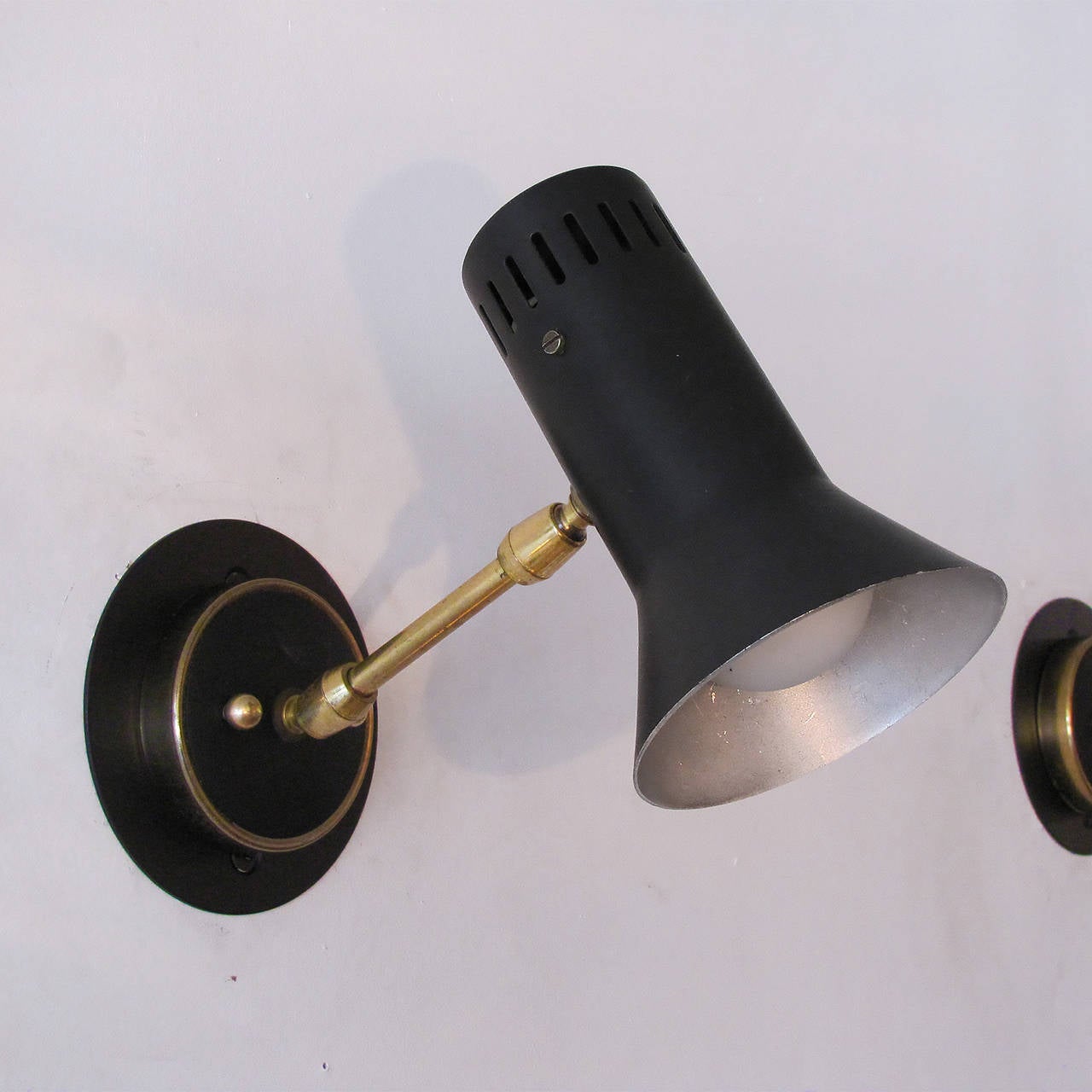 elegant, articulate pair of Italian wall lights, double joint brass arms, slotted partially conical shades, priced as a pair