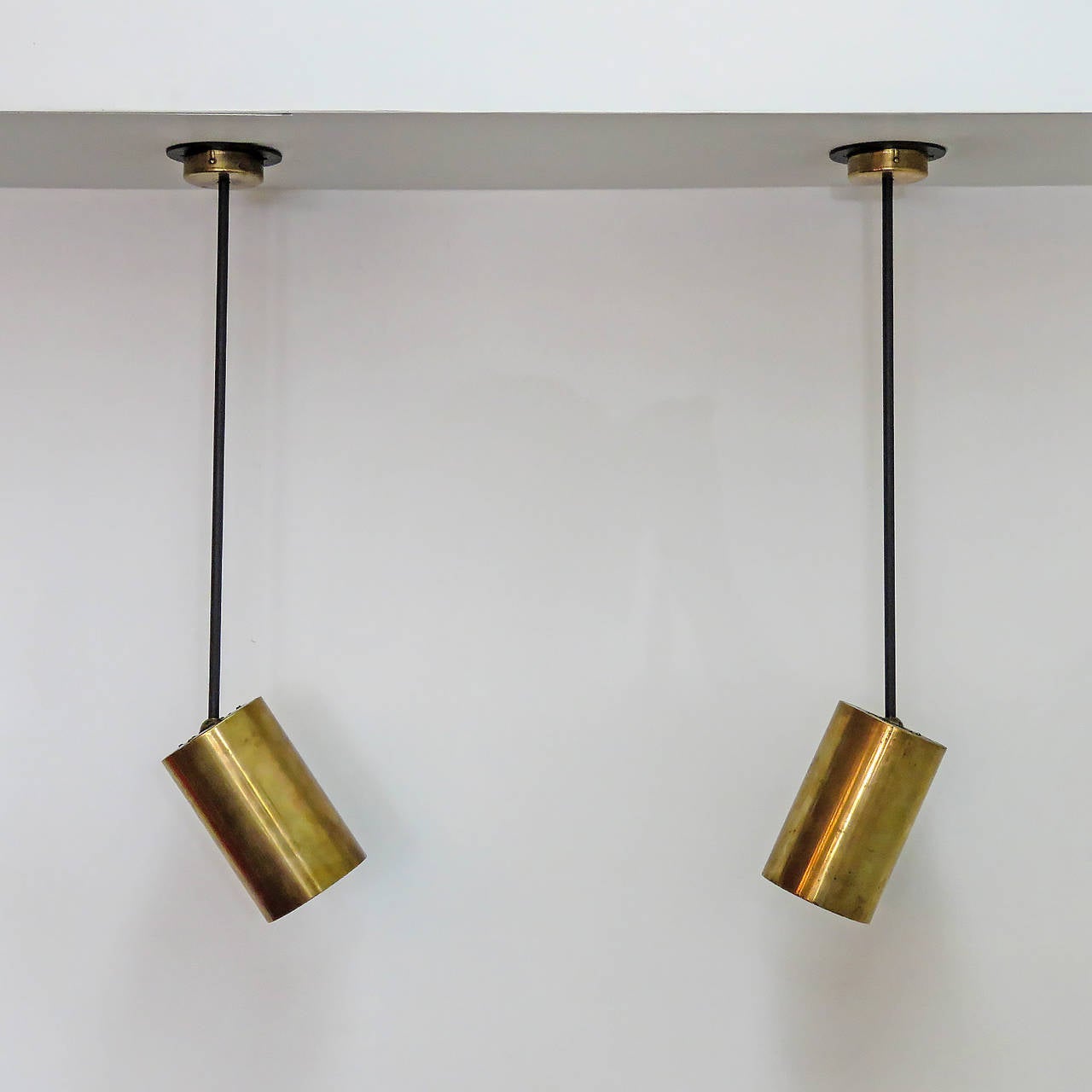 great pair of understated French ceiling lights by Parscot, long stem pendants with adjustable brass cylinders, can be used as wall lights, priced as a pair