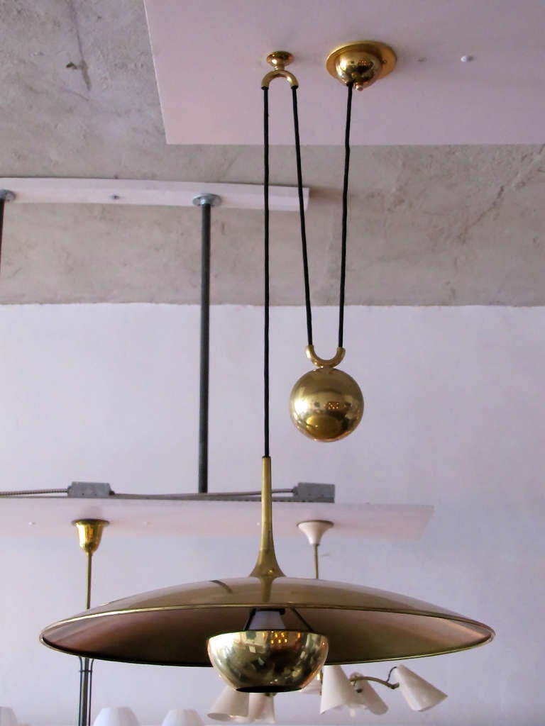large brass saucer with pully mechanism, a HEAVY brass ball counter balances the weight of the fully adjustable shade