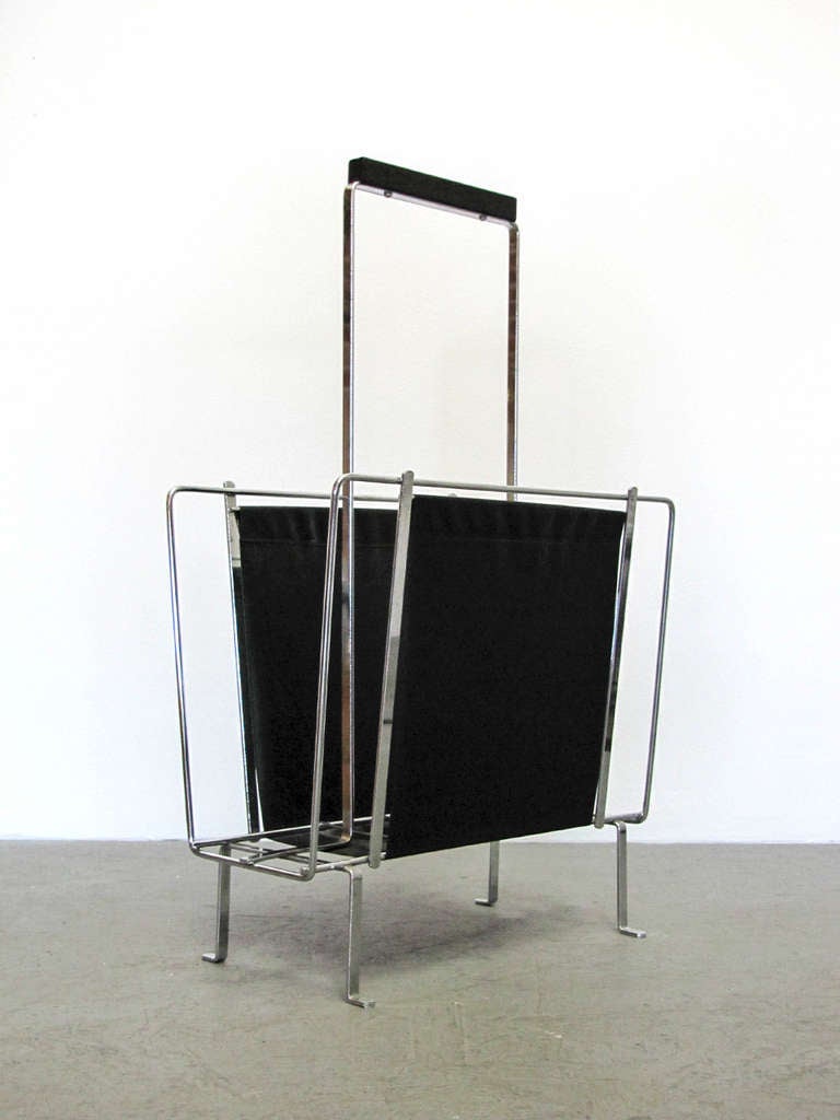 Elegant German 1960s magazine rack by Voss, chrome frame with textured black vinyl and wooden handle.