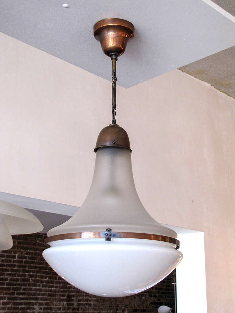 rare pendant in milk glass and frosted glass by Peter Behrens for AEG. Behrens was creative director for German industrial giant AEG and in 1907 started with Richard Riemerschmid the Deutsche Werkstatten, a very important forerunner to Bauhaus.
