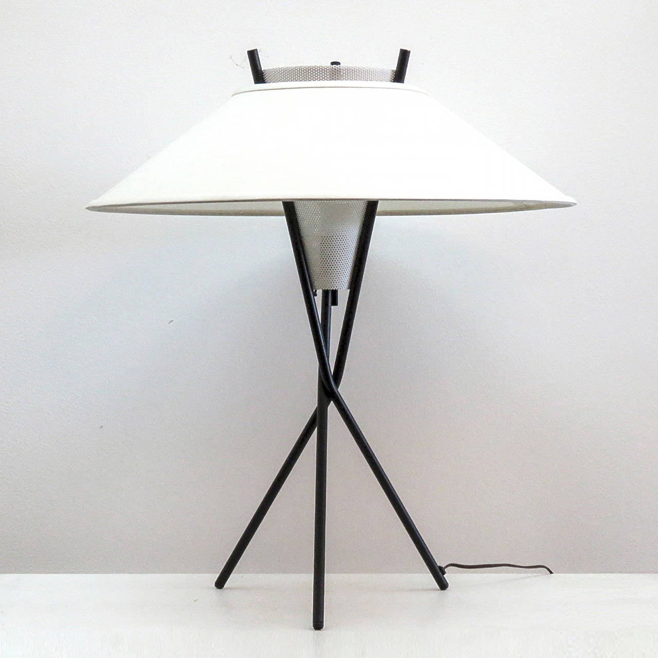 Elegant sculptural Gerald Thurston tri-pod table lamp with perforated white metal cone and custom shade, on/off switch under the center of the perforated cone.