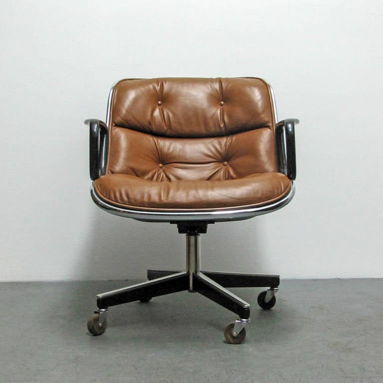 wonderful executive armchair designed by Charles Pollock for Knoll in 1956, in our favorite brown leather upholstery with black arms on a four star stainless steel swivel base with resin casters, 1974 production tags present, 1 chair available