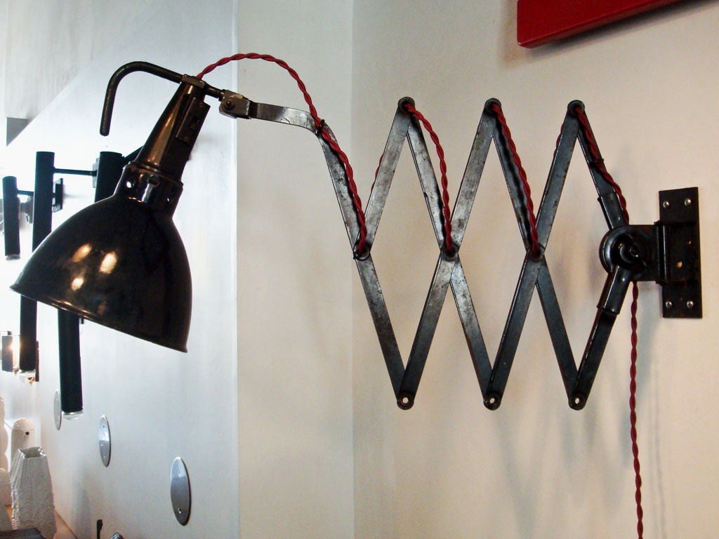 articulating black enameled metal scissor wall lamp by Kandem<br />
extends from 14