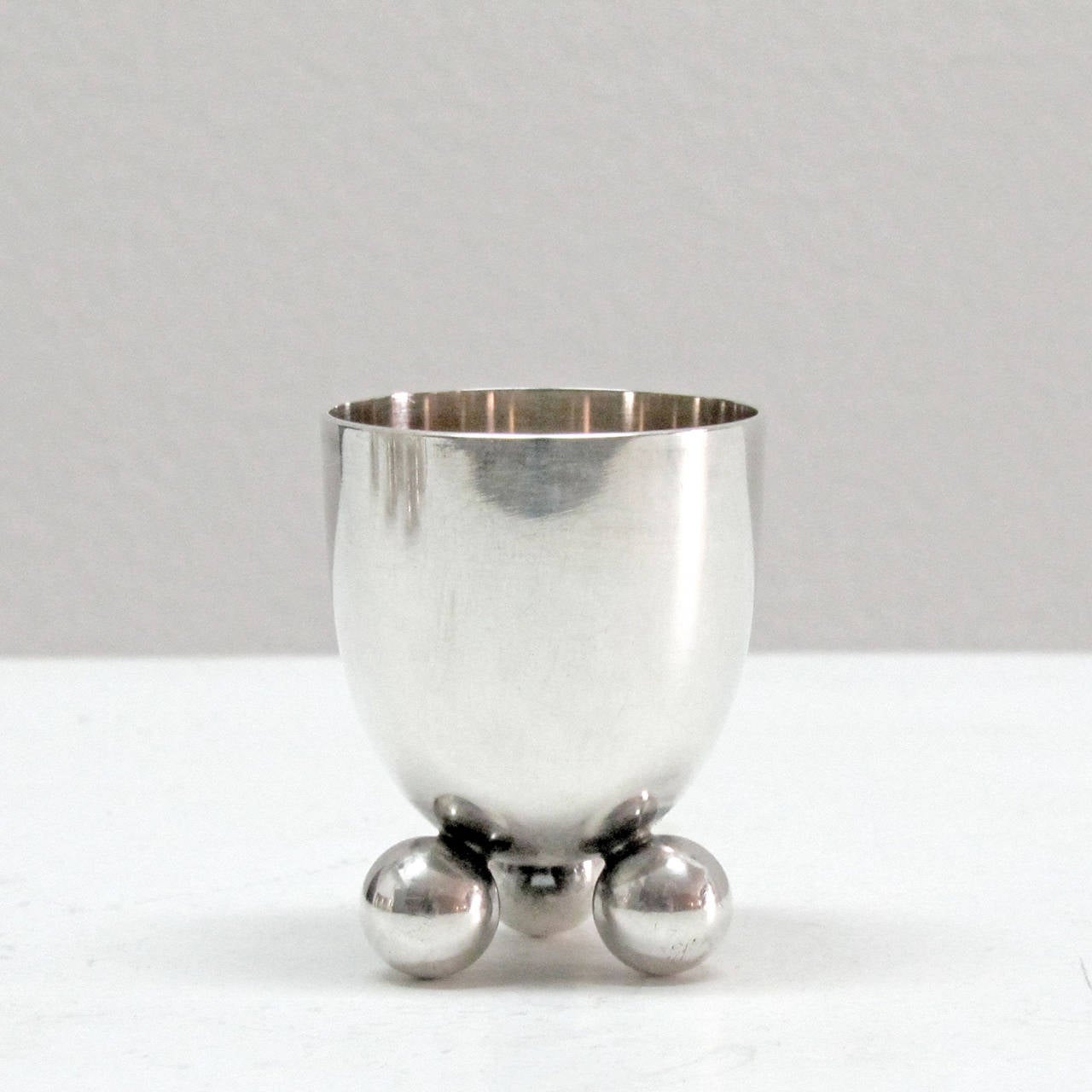wonderful set of six silver egg holders No.8154, by F. A. Breuhaus De Groot for WMF, each cup sits on 3 small solid spheres