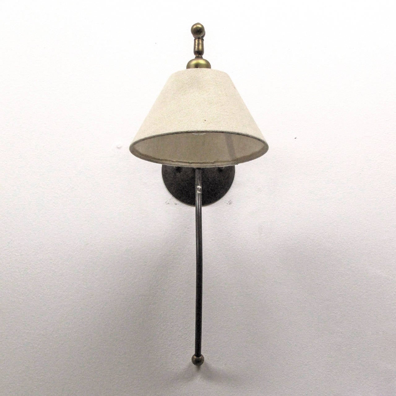 Wonderful large-scale iron wall lights in an oil rubbed bronze finish with brass details and original linen shades.