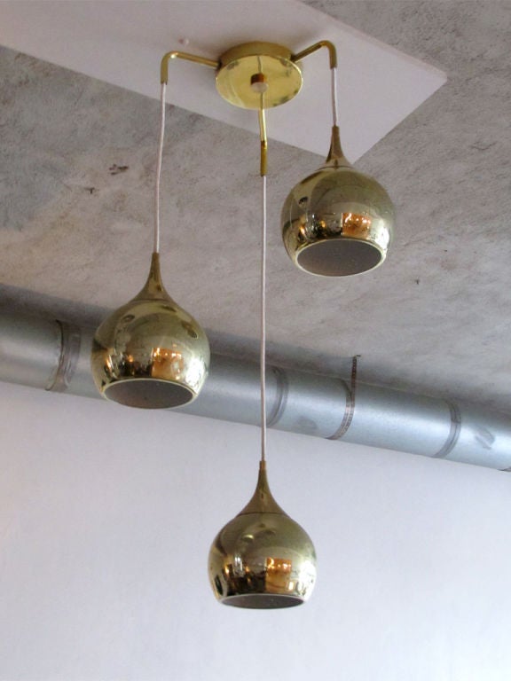 danish three pendant brass chandelier<br />
sensitively perforated globes can be installed individually<br />
optional custom drop with custom canopies available