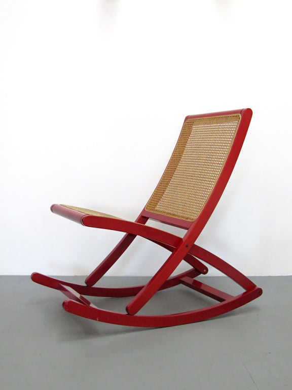 sleek modern rocking chair, features red finish wood frame,<br />
a cane back and seat. no damages, no repairs and the cane <br />
is in excellent condition.