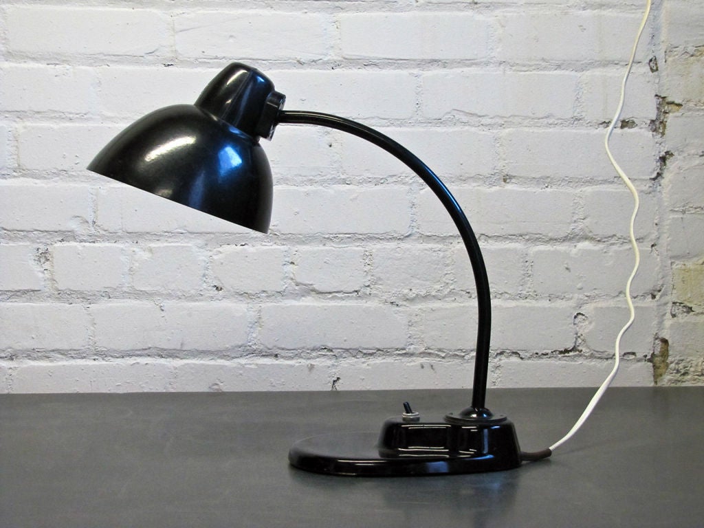 Kandem Task Lamp Model No. 1115, marked,bakelite shade <br />
on an enameled metal arm with ball joints on either end <br />
black glass base, priced individually