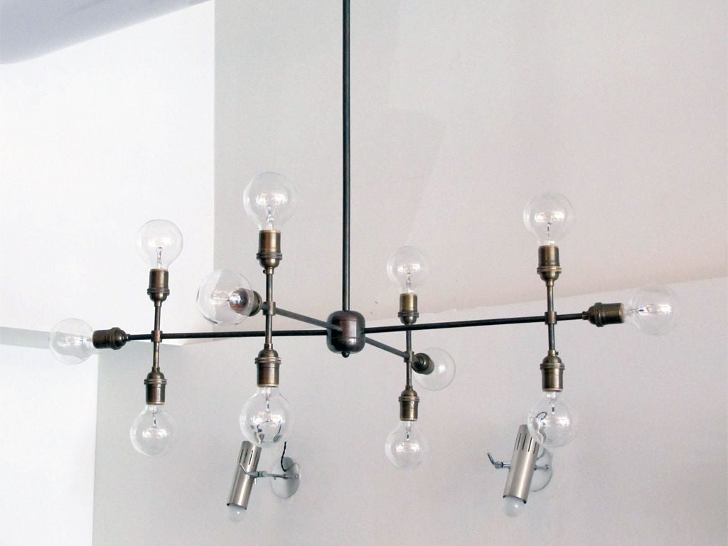 12 light brass chandelier inspired by cartographic imagery