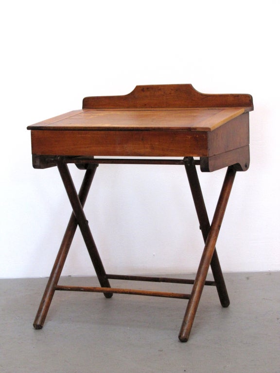 wonderful wooden children's desk
slanted top opens to reveal storage space
legs are collapsable, marked Paris MFG Co.