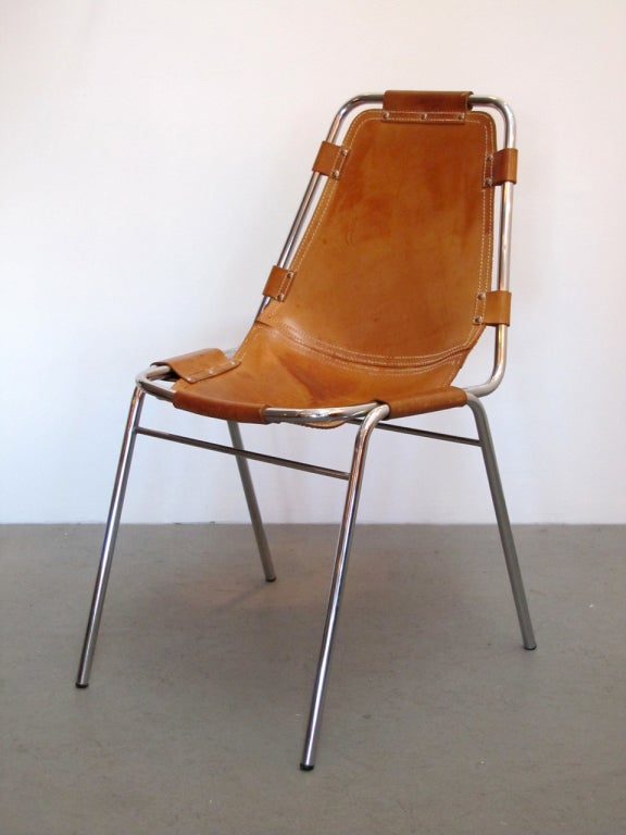 iconic leather and metal side chair by Charlotte Perriand for the Station Les Arc
tubular chrome frame and tan leather slung seat