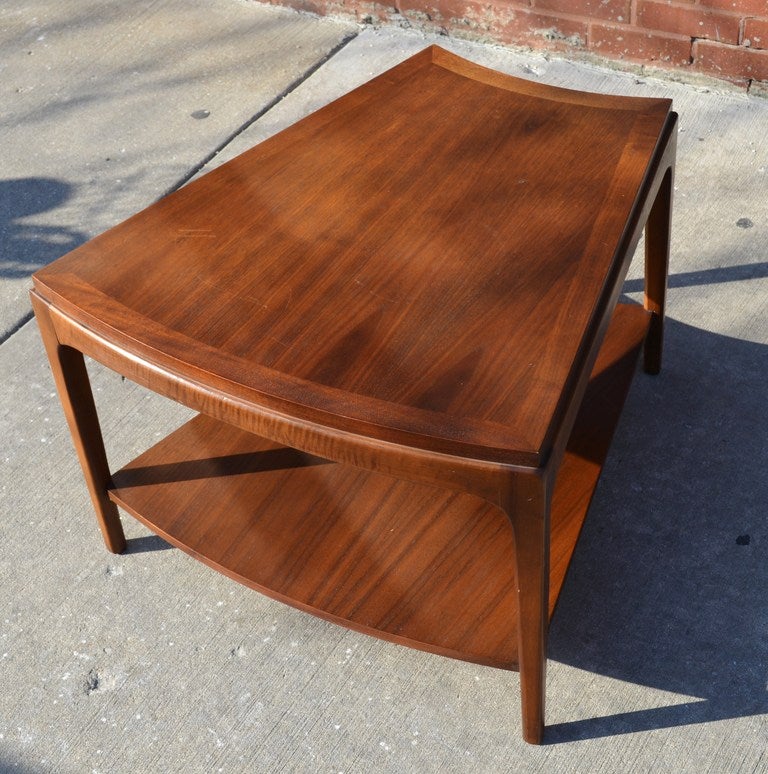 A two tiered wedge end table by Lane.