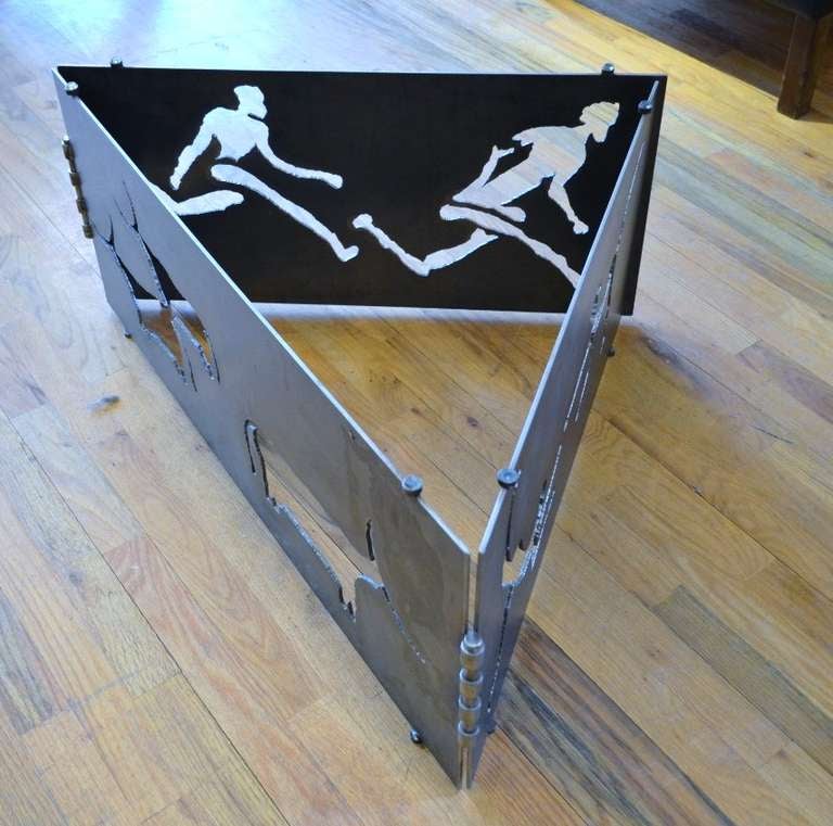 A torch cut steel coffee table featuring running figures and long horn cattle.
Piece of  vintage art 