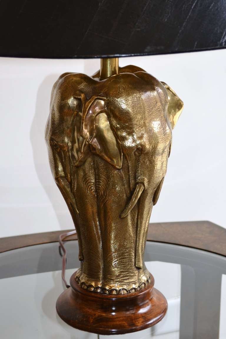 A brass Chapman lamp comprised of a herd of Elephants. Original faux leather embossed shade with gold interior.