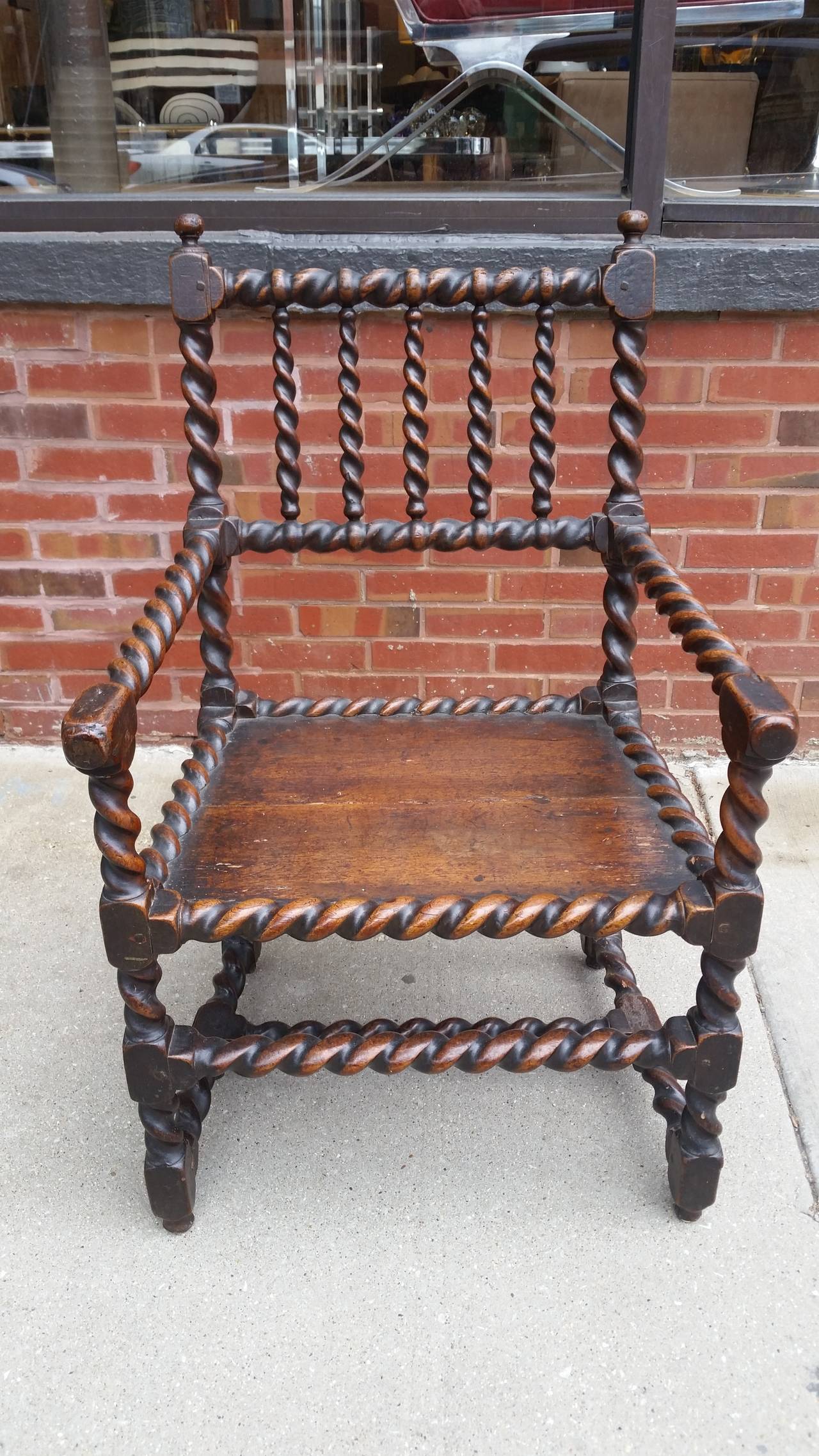 A sturdy oak early Jacobean chair. The chairs back, arms and stretchers are
all hand-turned barley twists. Overall the chair has a wonderful warm patina.
