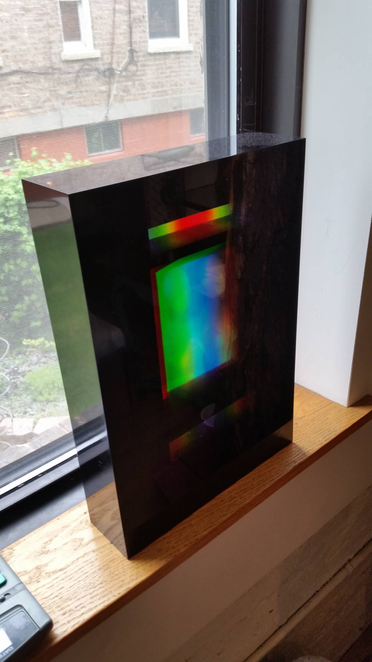 An impressive Hologram set in a thick Lucite block.
The middle Hologram is of two women and is flanked by two multicolored bands.
Purchased from a Chicago art collector. The piece is not signed.
This object does not photograph well.
In person