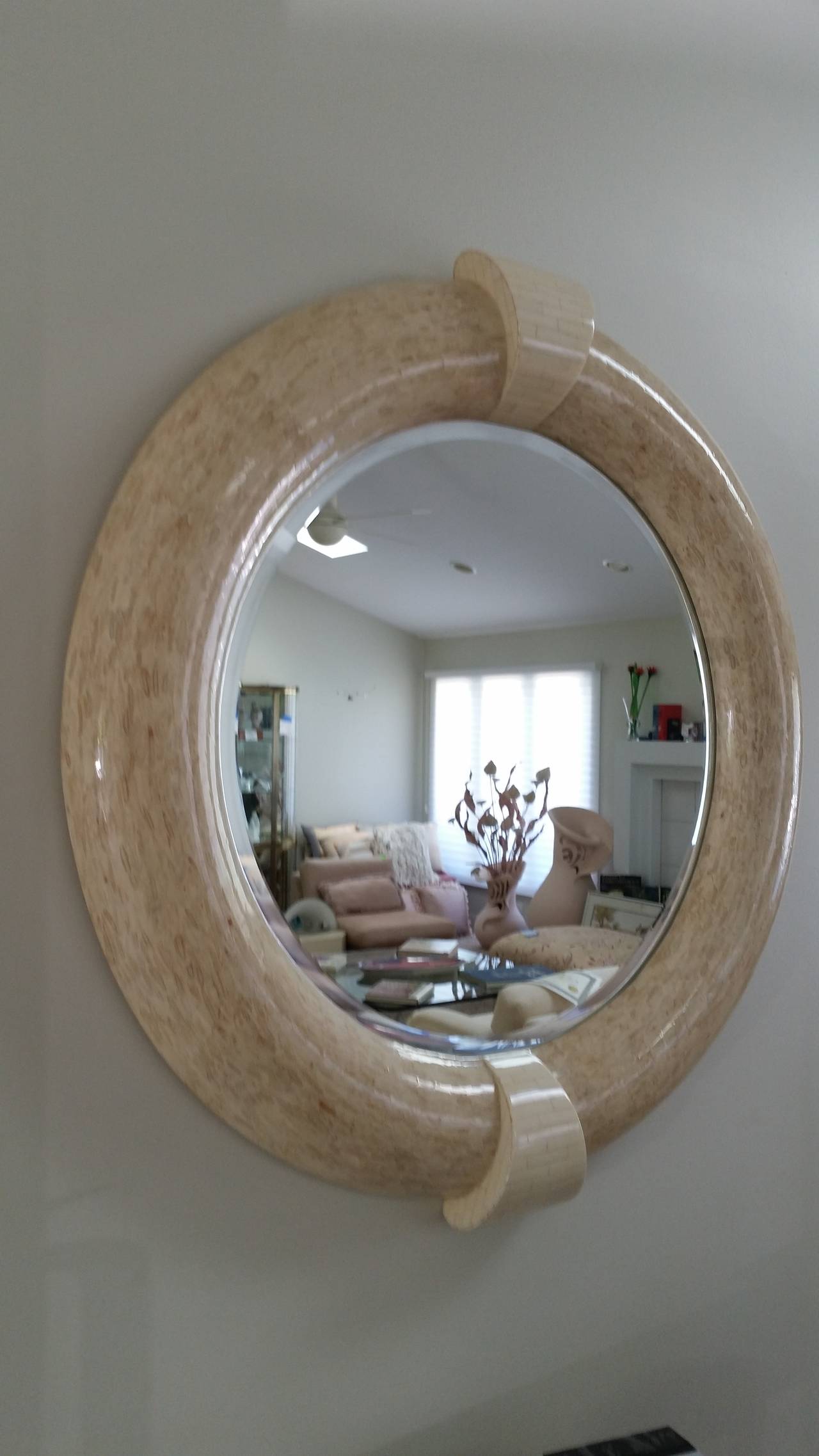 Karl Springer style round tessolated stone mirror. The keystones are tessellated in bone and the frame is tessellated in antlers.
