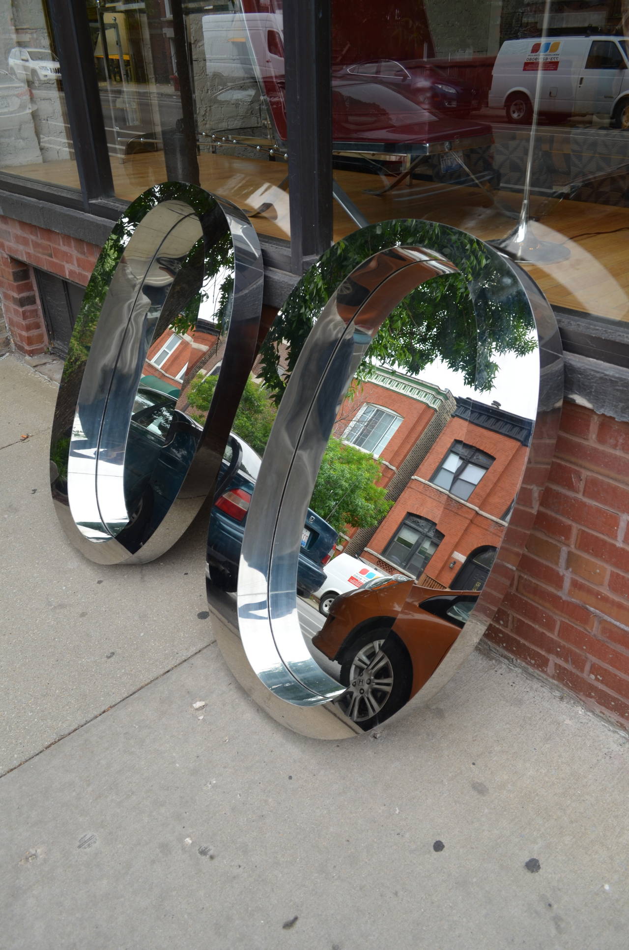 Late 20th Century Pair of One of a Kind Modern Oval Stainless Steel Mirrors For Sale