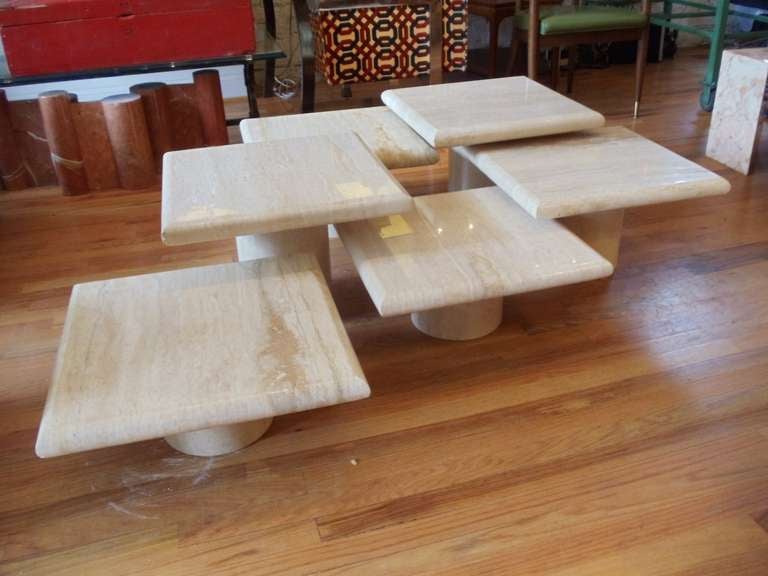 This magnificent Italian coffee table is comprised of six individual 20x20 travertine tables. Two tables are 14 inches high, two are 12 inches high and two are 9 inches high. This versatile coffee table could be configured to suit your individual
