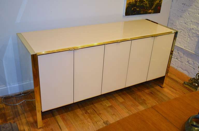 An Ello brass and glass clad five door credenza.