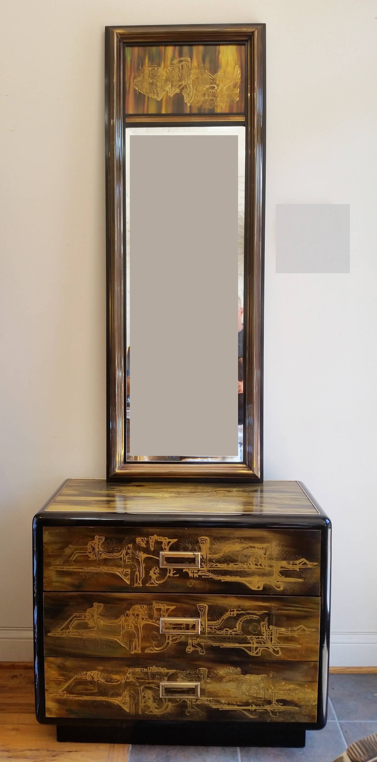 A brass long beveled mirror and three drawers cabinet by noted Mastercraft artist
Bernhard Rohne. Its top and sides are clad in iconic
Rohne acid etched panels. The corners are black lacquered
radius edges. Would work well as a nightstand or entry