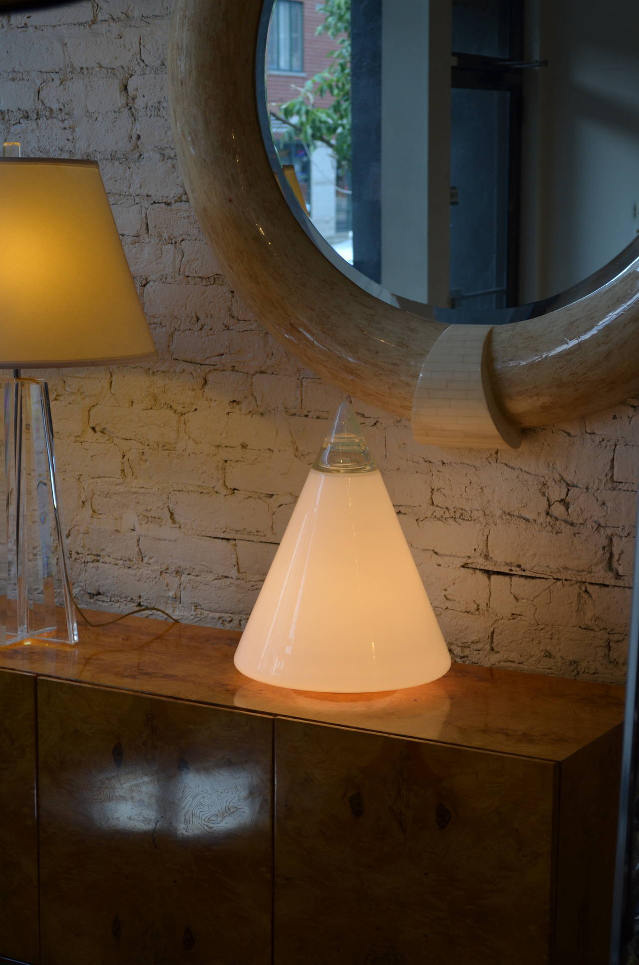 A fantastic heavy hand blown verti murano glass lamp by Leucos. Designed by Renato Toso and Roberto Pamio.
The large milky glass cone is topped by an opalescent finial.
Its base is metal. Wonderful lite at night.