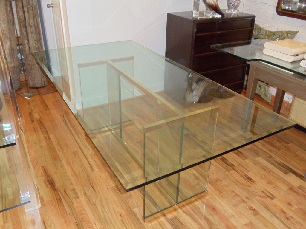 A Pace brass and thick glass dining table. The table is a large versatile size which could also be used as a desk.