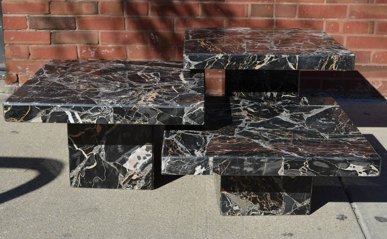 A trio of Italian coffee tables constructed of richly veined Portoro Marble.

These versatile tables offer multiple configuration options.

Table heights are 15, 12, and 9 inches.