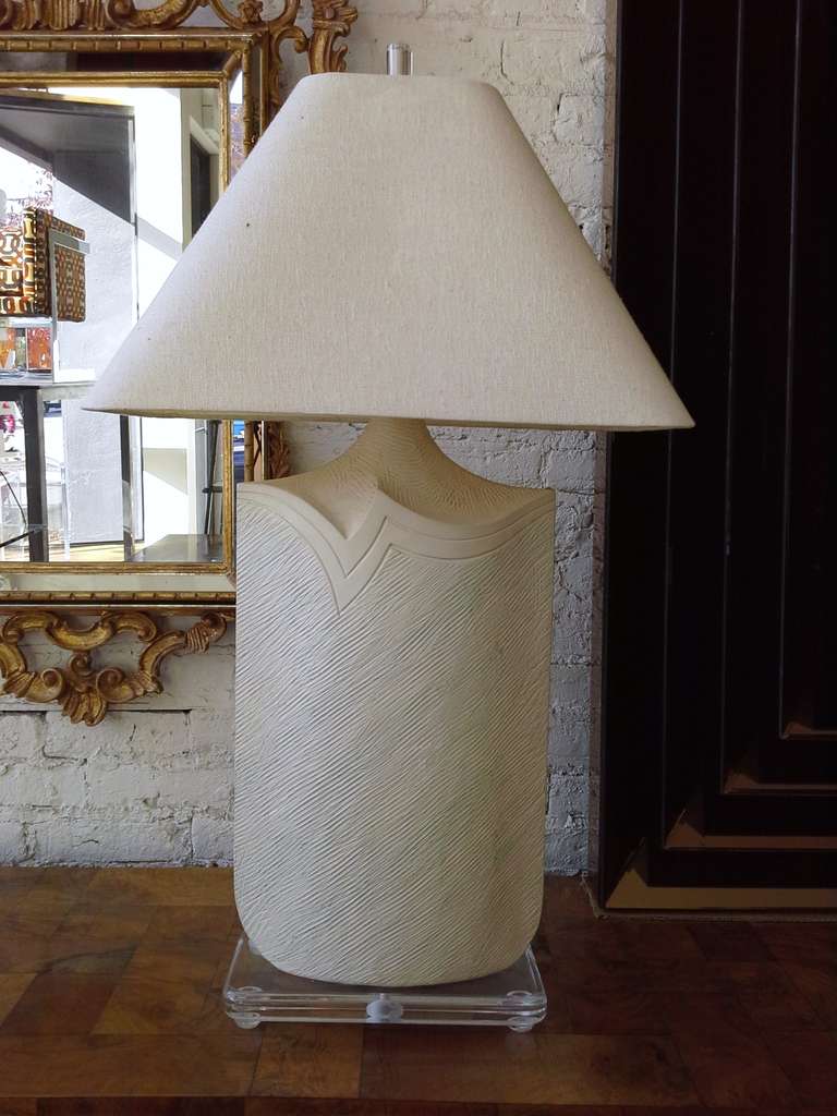 A slim profile plaster and Lucite table lamp by casual lamps.
Great slim elegant profile.