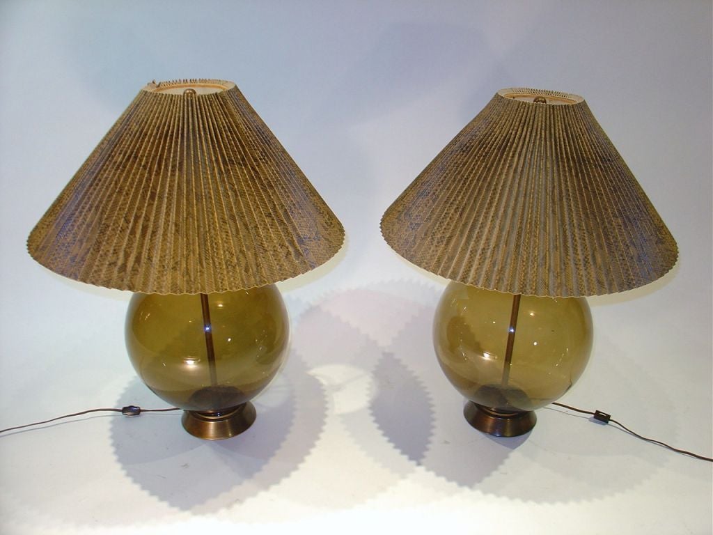 A pair of Tyndale tinted glass globe lamps.