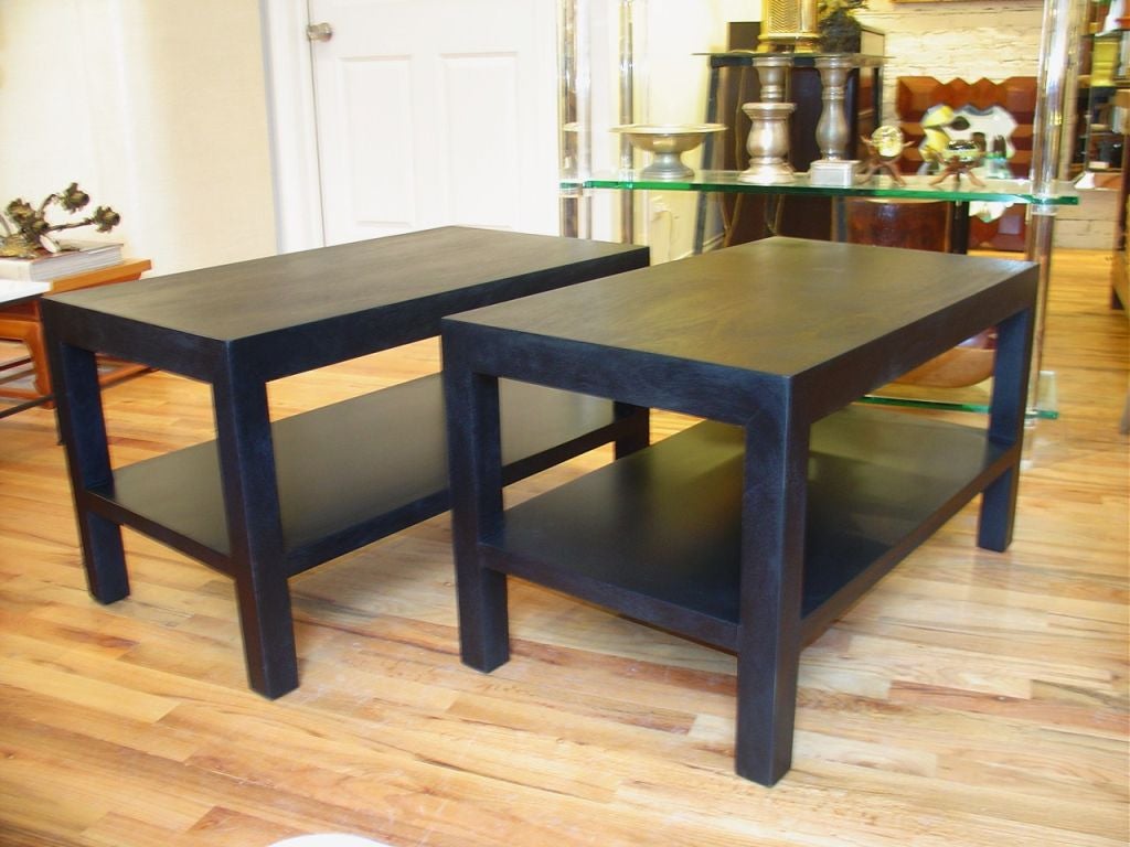 A pair of parsons style end tables with lower shelf. Great proportions.