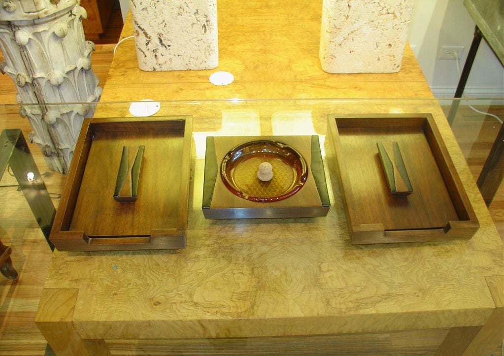 A 1960s walnut desk set with leather accents comprised of an in and out box and ashtray. The set is expertly crafted.