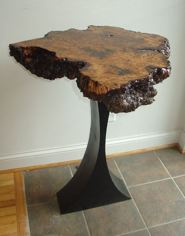 A burled console table with a metal base.
