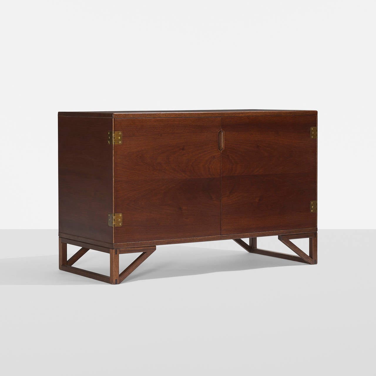 Cabinet features two doors concealing two adjustable shelves and three drawers.