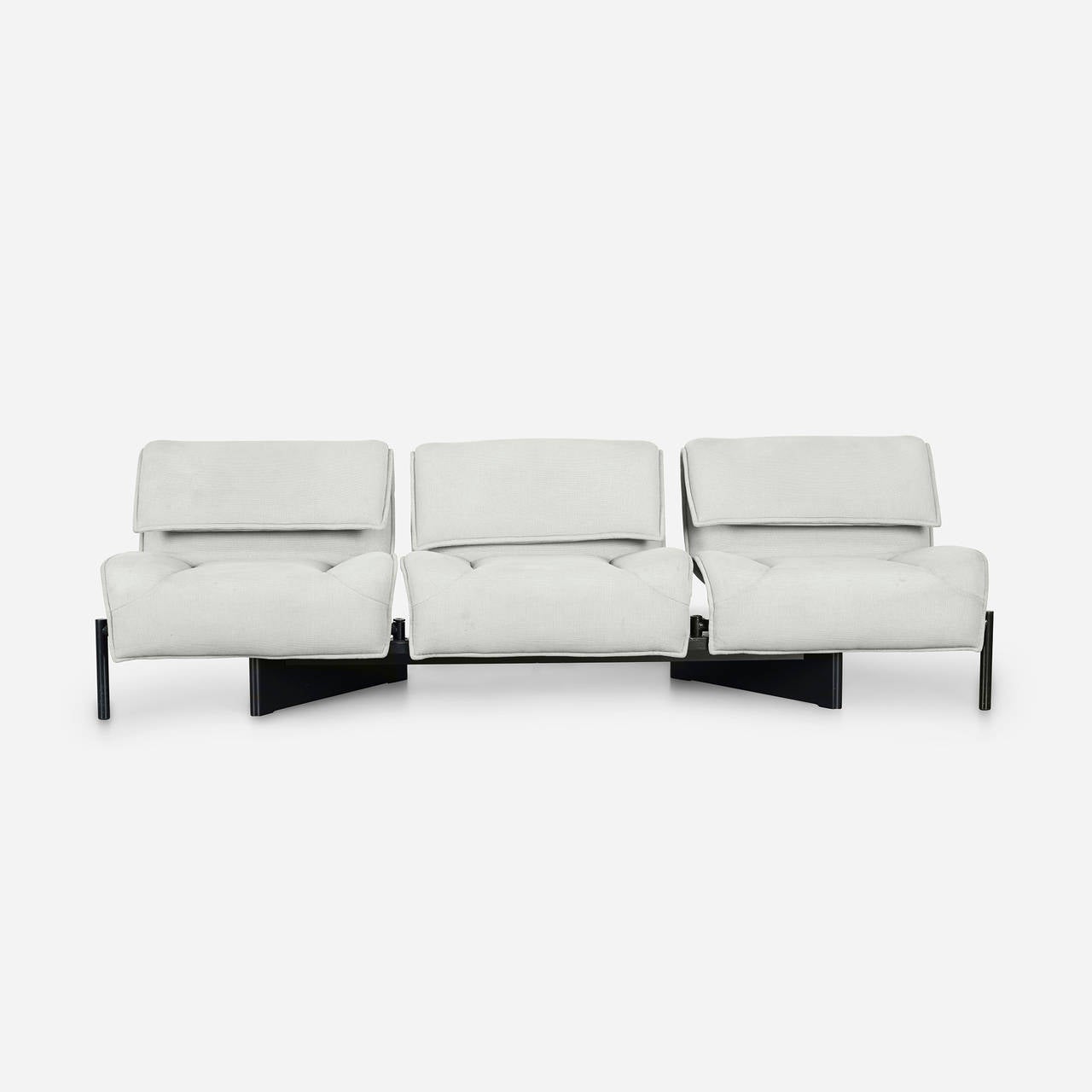 Sofa features three sections that can be rotated to create separate seats.