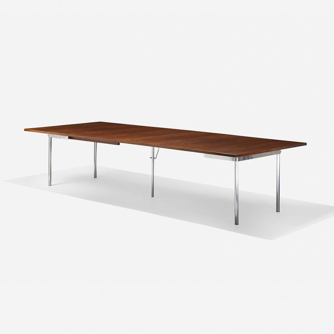 Sold with two 31.5-inch leaves; table measures sixty-three inches when not fully extended. Signed with branded manufacturer's mark to underside: [Andr. Tuck Design Hans J. Wegner Made in Denmark]. Sold with a copy of the original invoice.