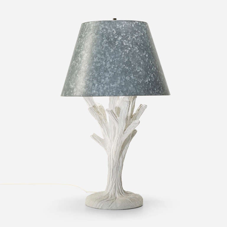 This rare table lamp by John Dickinson has exceptional presence. Dickinson sculpts a large coral form in his signature white plaster, topping it with a metal shade that heightens the dramatic monochromatic tones of the design. 
