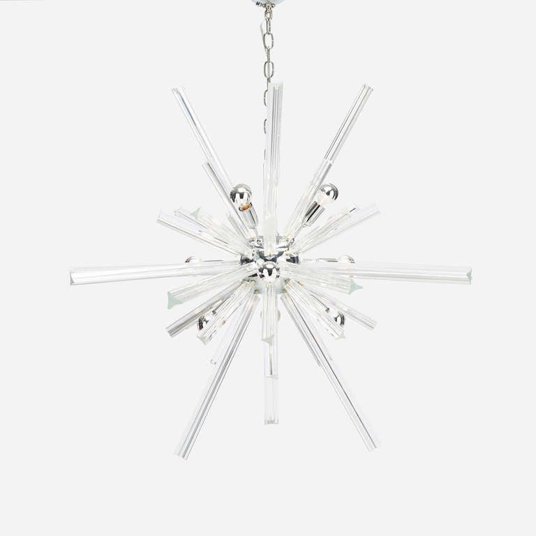 A 20th century chrome-plated steel and crystal chandelier, comprised of 1 fixture, 16 longs, 24 shorts.