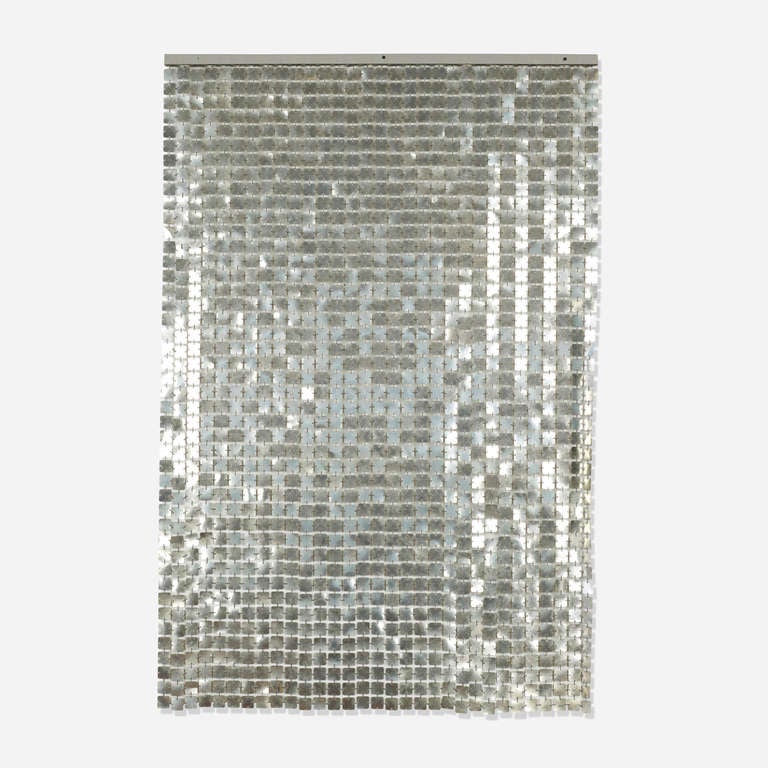 Although Paco Rabanne was trained as an architect, he is better known as a fashion designer. Rabanneâ??s love of textiles manifests in the Space Curtain, a shimmering, flexible sheet of interconnected plastic squares which throws off sparks of light.