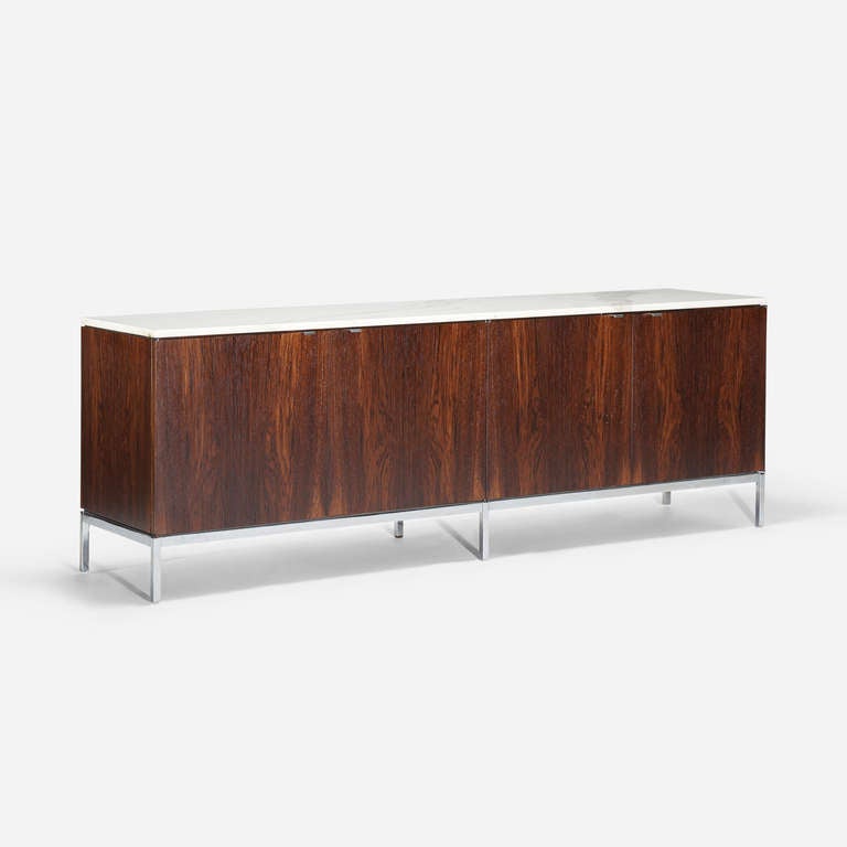 Cabinet features four doors concealing six adjustable shelves. Signed with decal manufacturer's label to underside: [Knoll Associates Inc.].