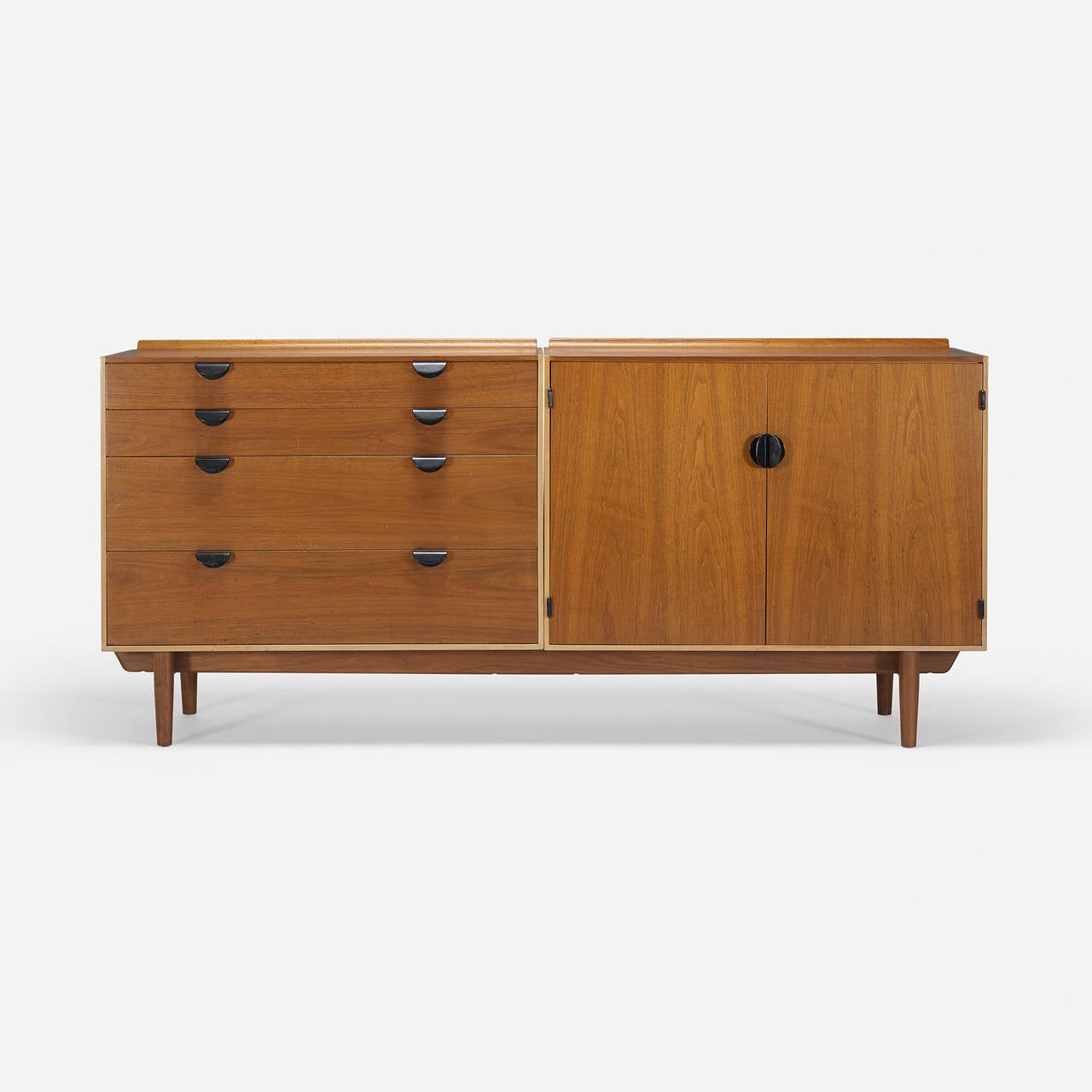 Cabinet features four drawers and two doors concealing two drawers and two adjustable shelves. Signed with applied metal manufacturer's label to interior: [Baker Furniture].