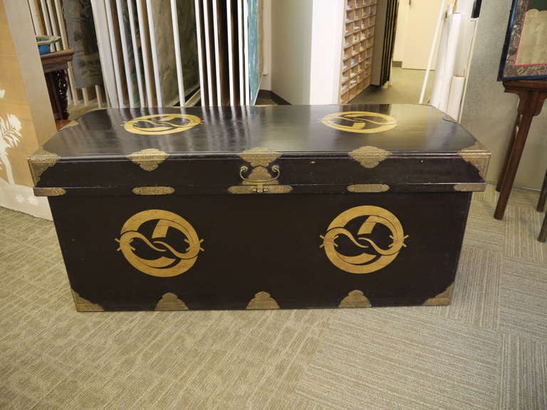 Very large Japanese 19th century storage chest (Nagamochi), with gold crests on all sides, and metal hardware, including handles.