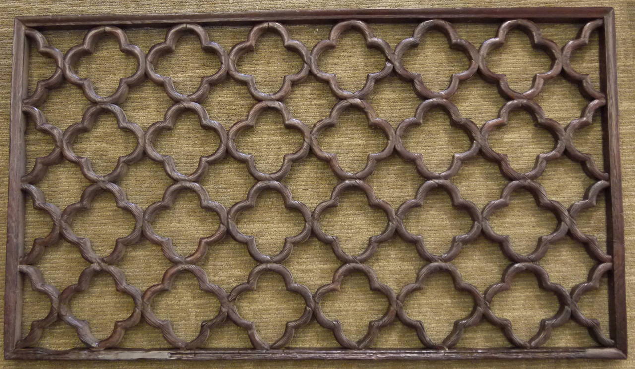 A large carved Chinese wooden lattice patterned window panel.