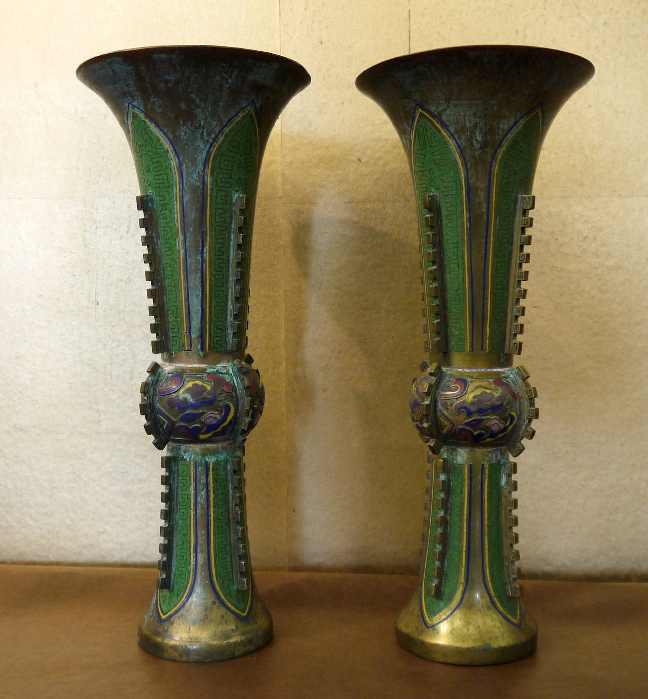 A pair of vintage Chinese cloisonné Ku shaped vases, with multicolored design of stylized clouds at center portion.